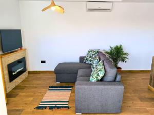 a living room with a couch and a tv at Casa LaLa in El Roque