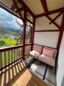 a screened in porch with a bench and a window at Villa Bella Vita in Seeboden