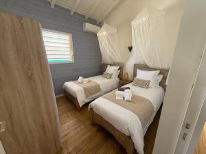 a bedroom with two beds and a window at Blue Horizon in Vieux-Habitants +63 photos