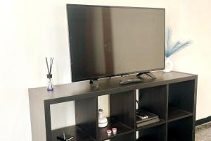 a flat screen tv sitting on top of a entertainment center at Mary's Home Cogoleto in Cogoleto