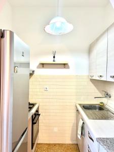 a kitchen with a sink and a refrigerator at Mary's Home Cogoleto in Cogoleto +10 photos