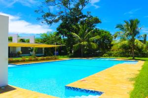a swimming pool in front of a villa at Lihanda Villa in Kilifi