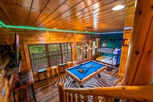 a room with a pool table in a cabin at Smoky Haven Retreat By Beyond Expectations in Pigeon Forge