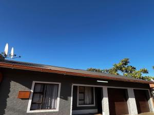 a house with a blue sky in the background at Traquil Stays BnB in Klerksdorp