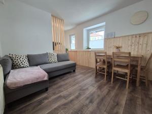 a living room with a couch and a table at Holiday Home Mila in Spodnja Idrija