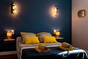 a bedroom with a bed with yellow pillows on it at Pays Basque Gite Munhoa in Anhaux