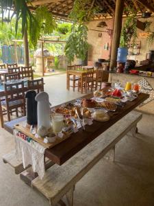 a wooden table with food on top of it at Pousada Rural Vista do Limoeiro in Itabira