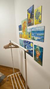a display of paintings on a wall in a room at La Casa Blu Rimini in Rimini