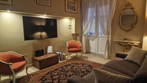 a living room with a couch and a tv at La Casa tra i Caruggi in Genova