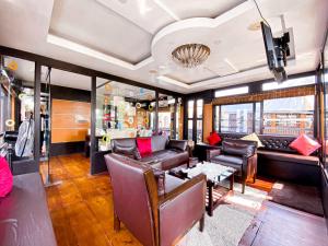 a living room with a couch and a table at Marvelous Boathouse in Alleppey