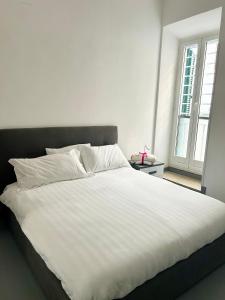 En eller flere senge i et værelse på Nuovo appartamento - Casa D'Amaldi