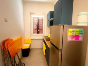 a kitchen with a refrigerator and a table and chairs at Modern and quiet apartment in Rome