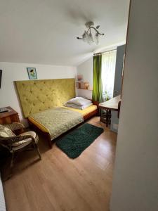 a bedroom with a bed and a chair and a table at Ośrodek Wypoczynku Natura w Nałęczowie in Nałęczów +19 photos