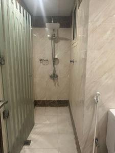 a shower with a glass door in a bathroom at فندق جولدن نيو ارمادا جيزان - شركة ارمادا الورود الفندقية in Jazan +14 photos