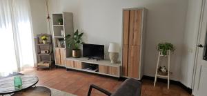 a living room with a tv sitting on a shelf at Spekenbrink in Haaksbergen