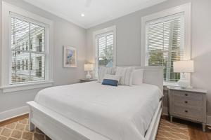 a white bedroom with a large bed and two windows at The Cavalla- private pool & roof top deck in Charleston +49 photos