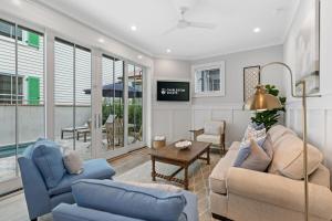 a living room with two couches and a tv at The Cavalla- private pool & roof top deck in Charleston