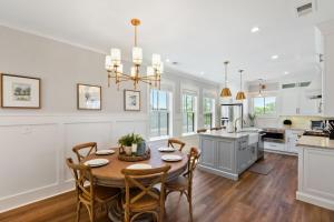 a kitchen and dining room with a table and chairs at The Cavalla- private pool & roof top deck in Charleston