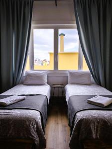 Ένα ή περισσότερα κρεβάτια σε δωμάτιο στο Ey Lisbon GuestHouse