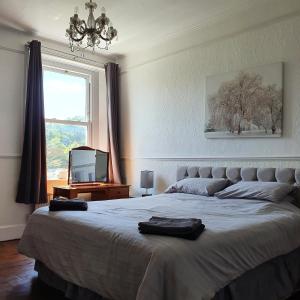a bedroom with a large bed and a window at Country Manor House in Higham