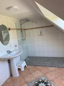 a bathroom with a sink and a mirror at Boardinghouse Südbrookmerland in Südbrookmerland