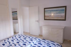 a bedroom with a bed and a painting on the wall at ELENA flat A little paradise right on the BEACH in Sitio de Calahonda +46 photos
