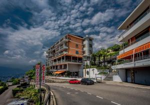 a red car is parked in front of a building at Hotel Colibrì in Lugano