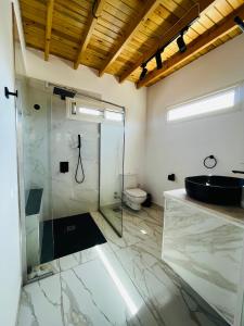 a bathroom with a glass shower and a toilet at Villa Vovan in Dahab +74 photos