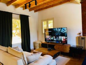 a living room with a couch and a flat screen tv at Villa Vovan in Dahab