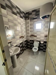 a bathroom with a toilet and a sink at RAAK HOTEL فندق راك in Siwa +38 photos