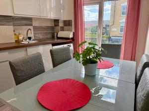a kitchen with a table with red umbrellas on it at Enormous Family Flat (7 guests) in London +10 photos