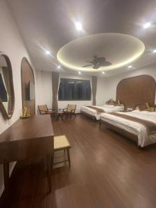 a large room with two beds and a ceiling at Maison Homestay Pho Bien 17, Ocean Park 3 in Ðình Loan