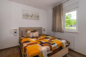 a bedroom with a bed and a window at Villa ForRest, a charming villa surrounded by beautiful nature in Križanici +30 photos