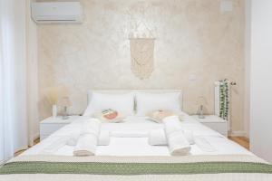 a bedroom with a white bed with two night stands at Pampas Roma in Rome