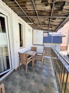 a patio with a table and chairs on a balcony at L's Apartment in Ohrid +4 photos