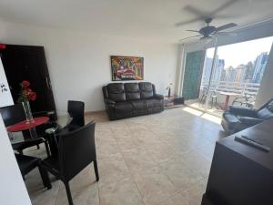 a living room with a couch and a table at Acogedor apartamento en El Cangrejo in Panama City +26 photos