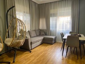 a living room with a couch and a table at Mandarine hostel in Tirana