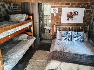 a bedroom with two bunk beds in a brick wall at Thaba Tshwene Game Farm in Modimolle