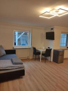 a bedroom with a bed and a table and chairs at Sonniges und modernes Apartment Casa Nobi in Gebenbach