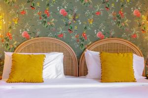 a bedroom with a bed with a floral wallpaper at Hôtel La Villa Sainte Valérie Adults Only in Juan-les-Pins