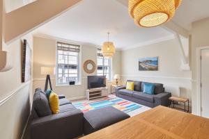a living room with two couches and a tv at Painters Modern Apartment Central Location in Scarborough