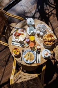 a wooden table with food on top of it at Hôtel La Villa Sainte Valérie Adults Only in Juan-les-Pins
