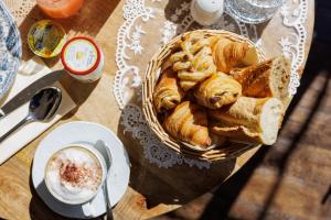 a basket of bread and a cup of coffee on a table at Hôtel La Villa Sainte Valérie Adults Only in Juan-les-Pins