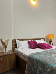 a bedroom with a bed with two pillows on it at The Label Stay Skyscraper in Gurgaon