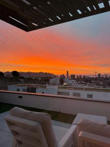 a view of a sunset from the roof of a building at SUNNY home in Finestrat +35 photos