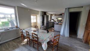a kitchen and dining room with a table and chairs at Maison de village in Corbonod