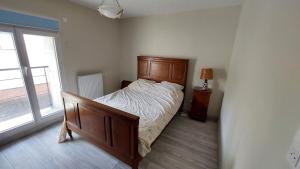 a bedroom with a bed and a large window at Maison de village in Corbonod