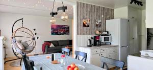 a kitchen and living room with a table and chairs at 3BR Home Near Lake Vänern - Covered Deck & BBQ in Otterbäcken