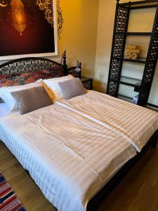 a large bed with white sheets and pillows at APARTMENTS VRANAS in Visoko