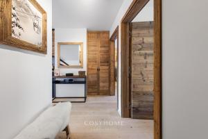 - un couloir avec une porte coulissante en bois dans une maison dans l'établissement Altitude l Superior l View l Parking l By CosyHome, à Crans-Montana